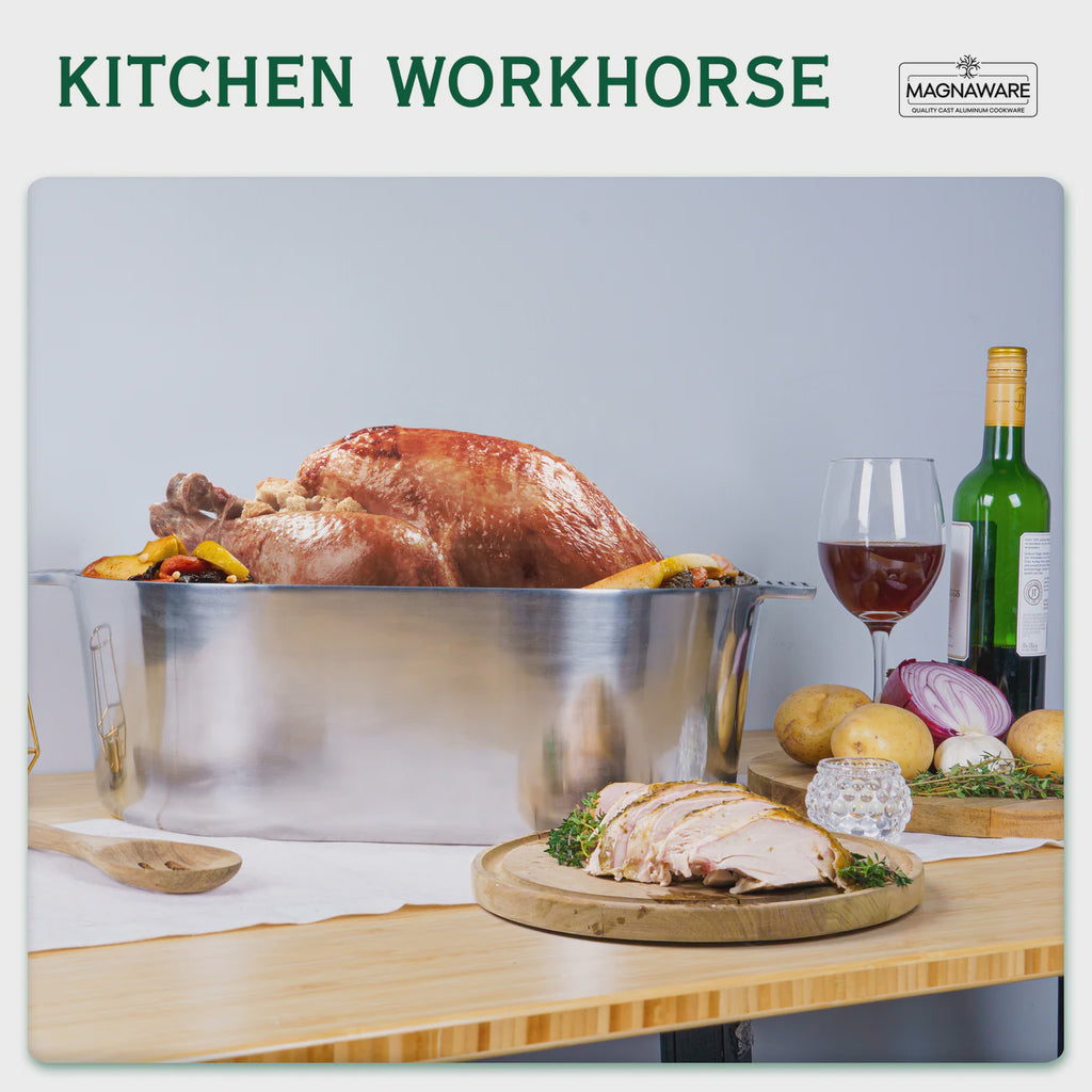 Aluminum dutch oven with roasted turkey, wine, and vegetables on a kitchen counter with 'Magneware' branding.