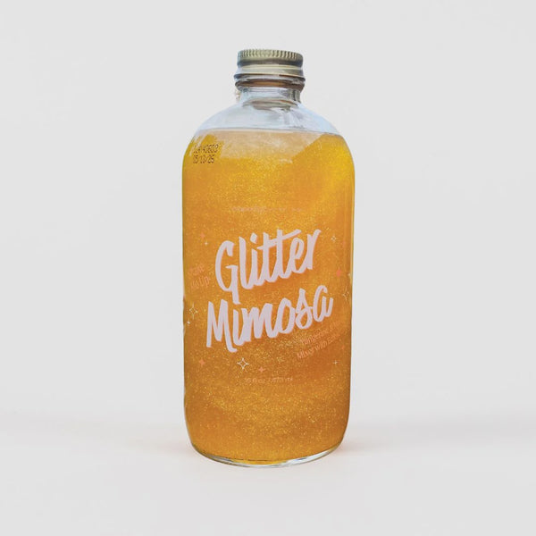 Bottle of 'Glitter Mimosa' on a white background