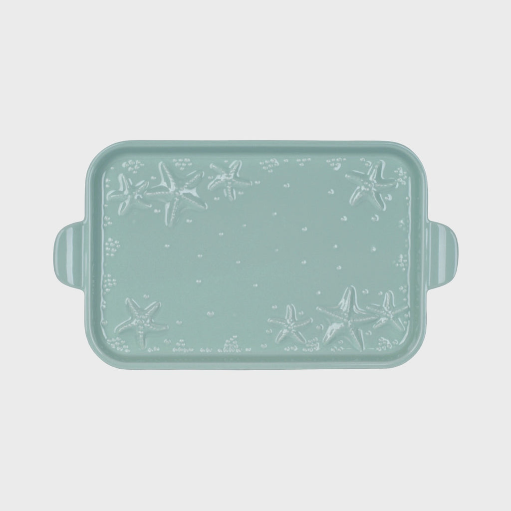Mint green rectangular serving platter with starfish pattern on a light gray background