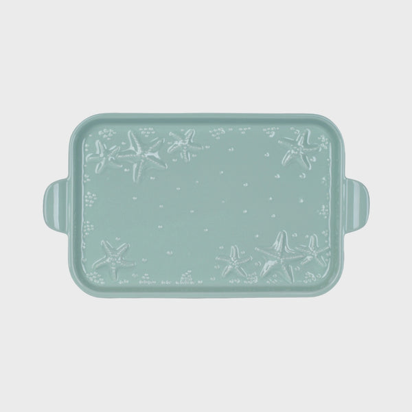 Mint green rectangular serving platter with starfish pattern on a light gray background