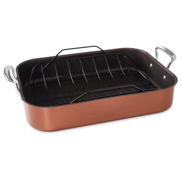 Copper roasting pan with black rack on a white background