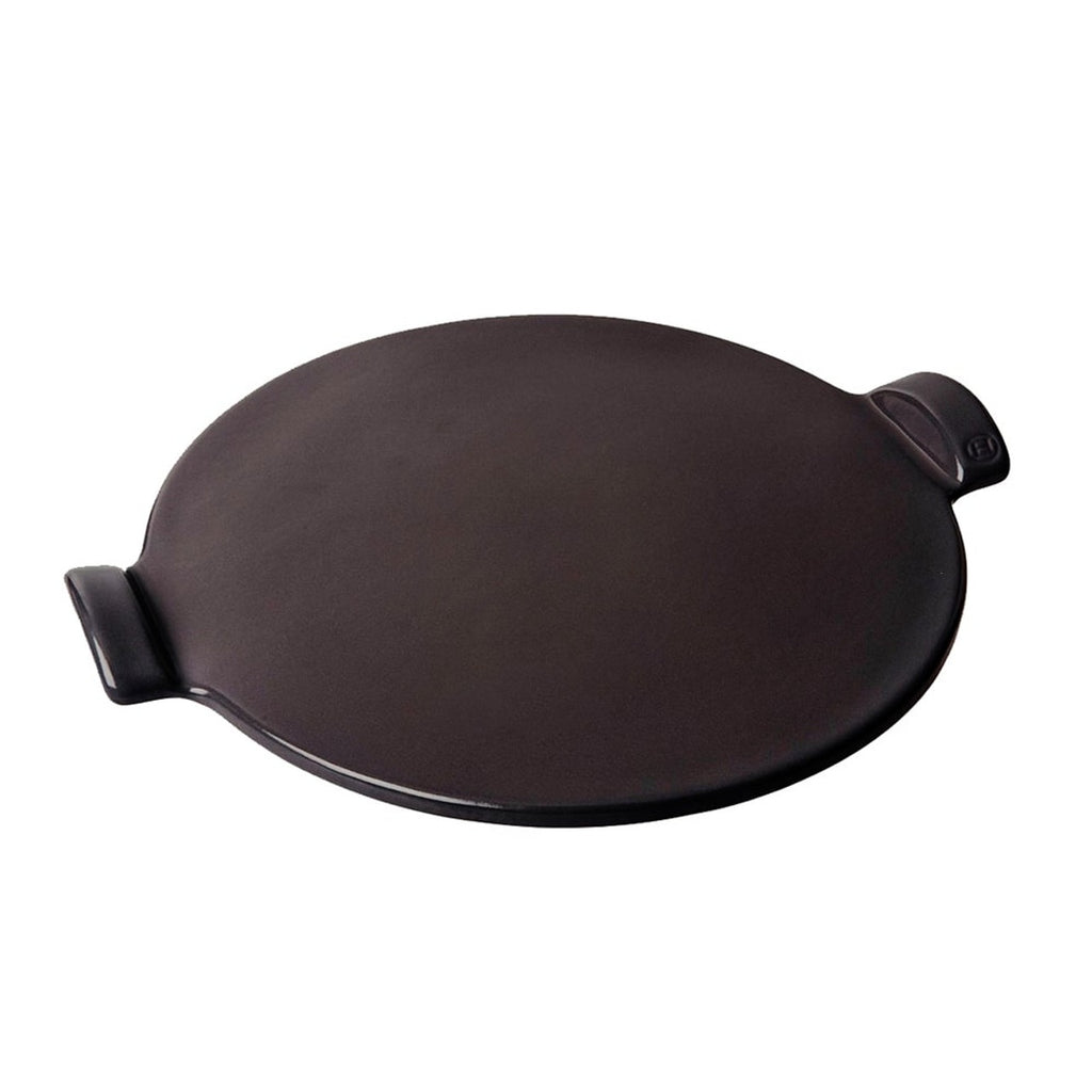 Round black smooth pizza stone on a white background