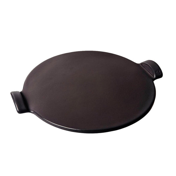 Round black smooth pizza stone on a white background