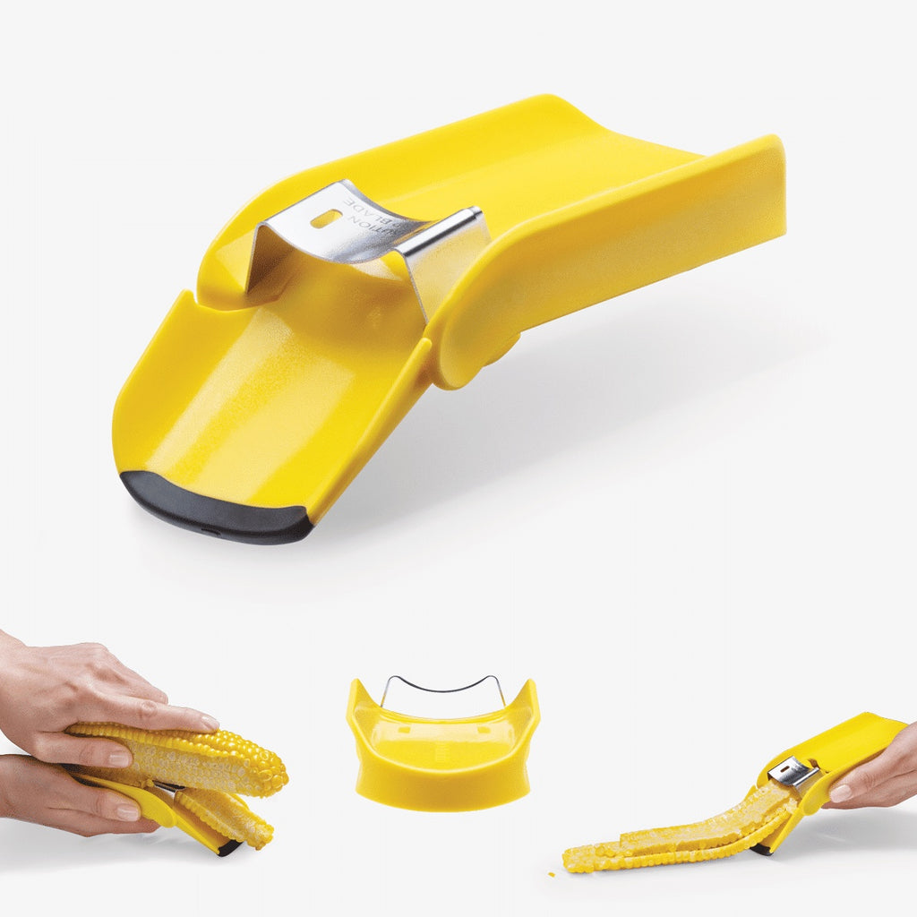 Yellow corn sheller being used on a white background